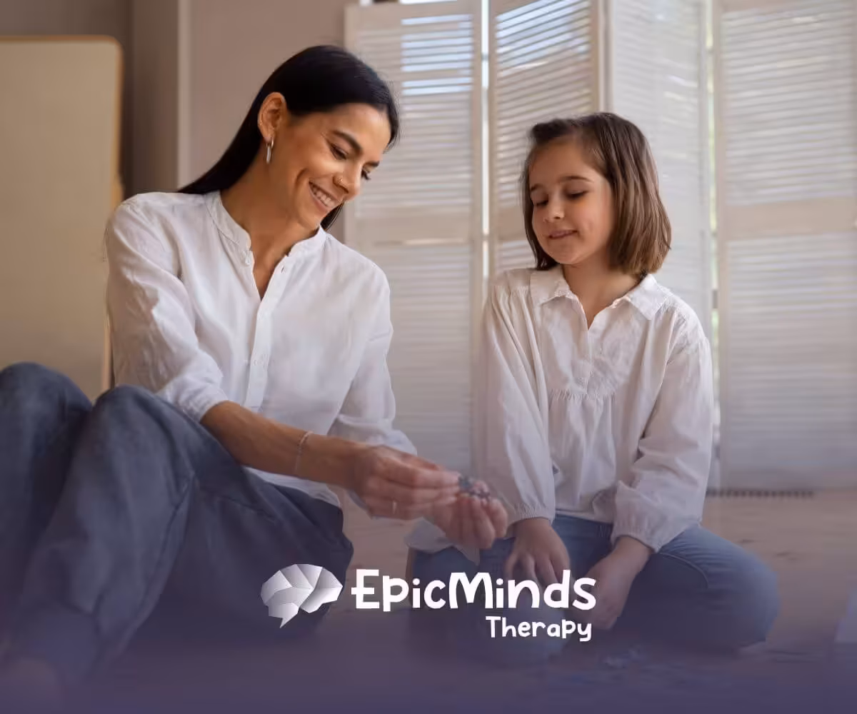 Smiling ABA therapist and autistic girl solving a puzzle together on the floor in ABA therapy.