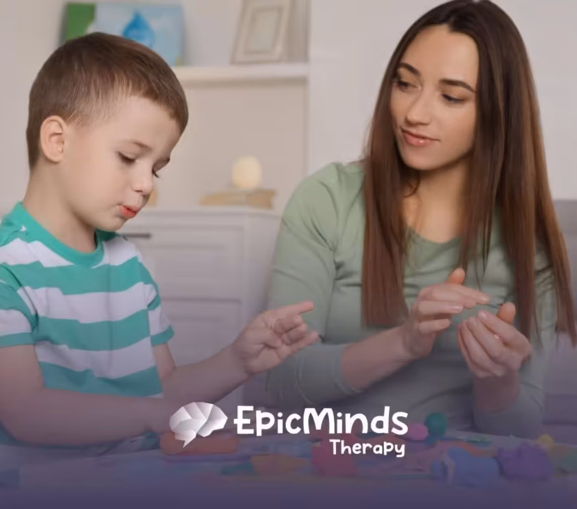 ABA therapist and autistic child playing with colorful playdough in ABA therapy.