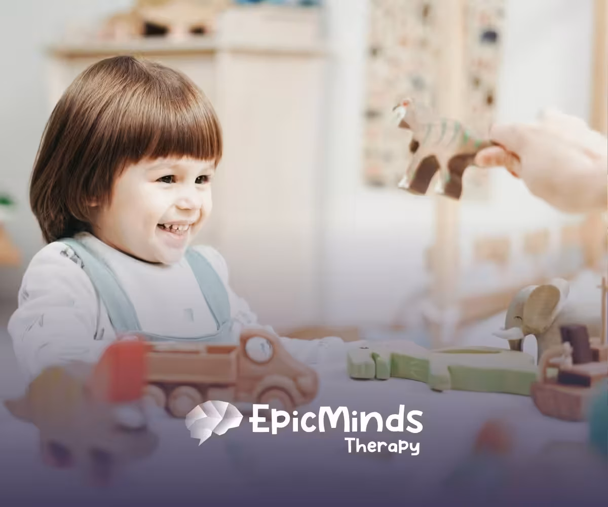 An autistic girl holding and inspecting a wooden toy helicopter at a table during ABA therapy in MD.