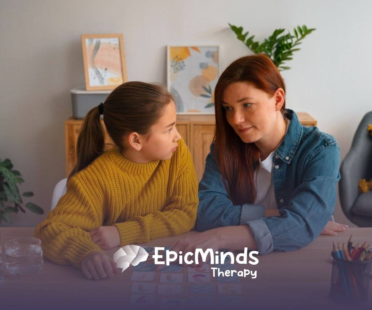 ABA therapist and autistic child playing a memory game with cards in ABA therapy.