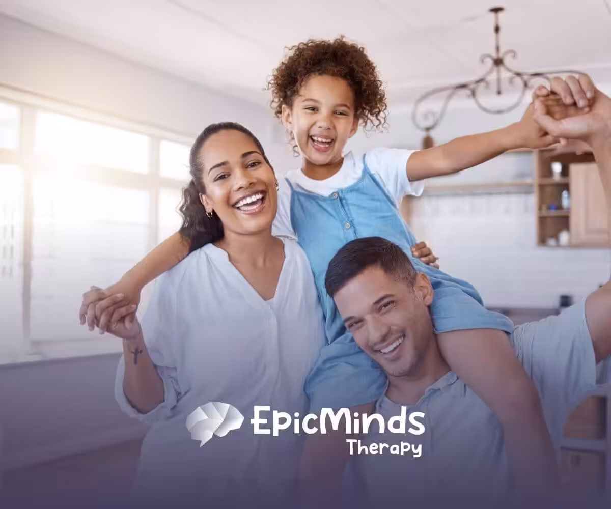 A happy family of three smiling together in a bright kitchen.