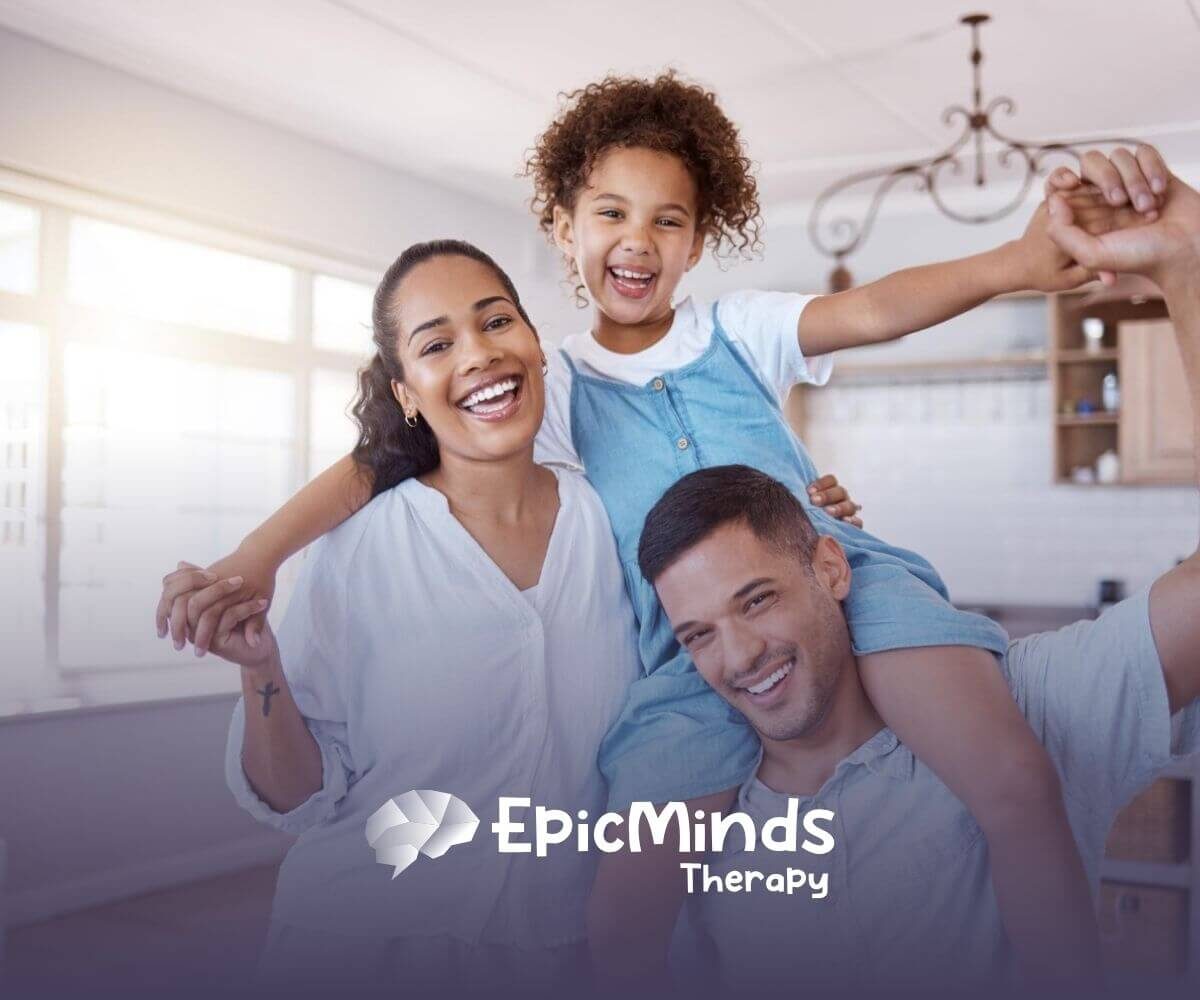 A happy family of three smiling together in a bright kitchen.