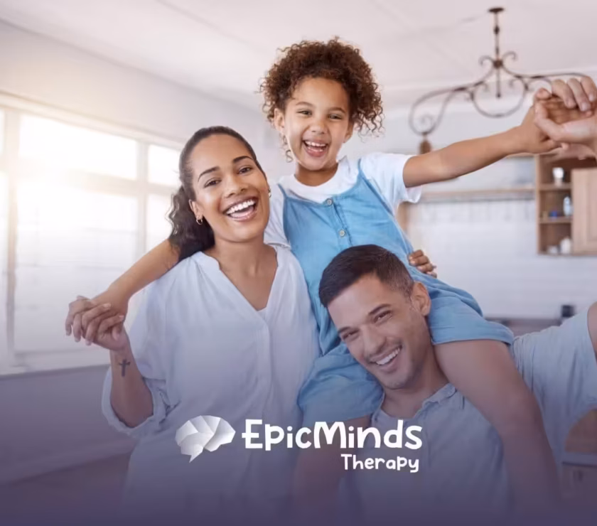 A happy family of three smiling together in a bright kitchen.