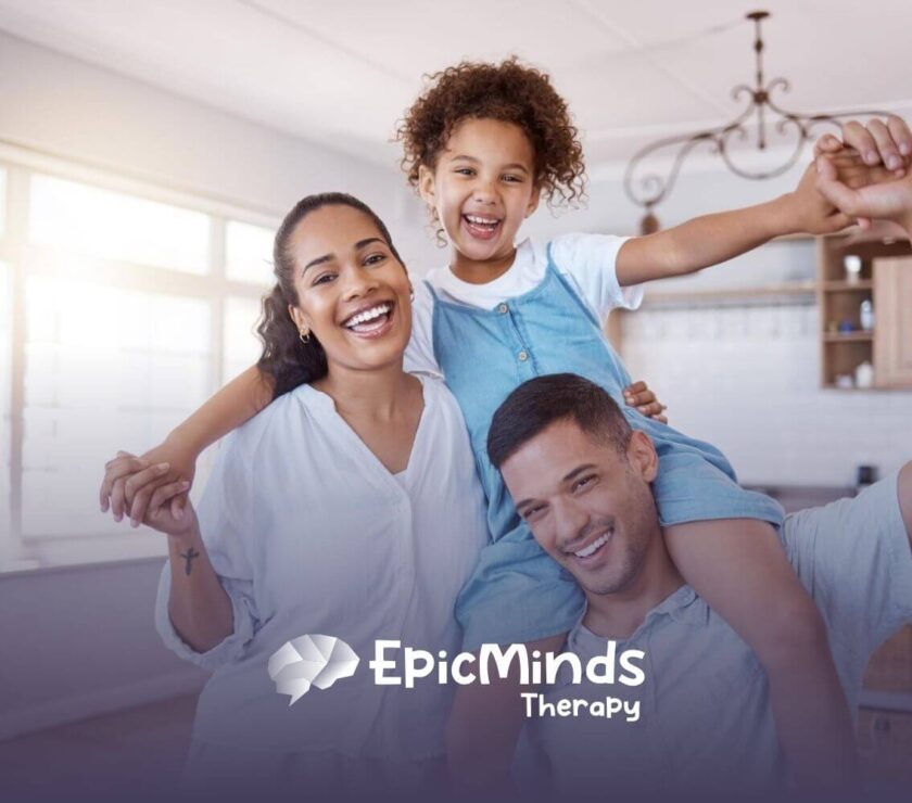 A happy family of three smiling together in a bright kitchen.