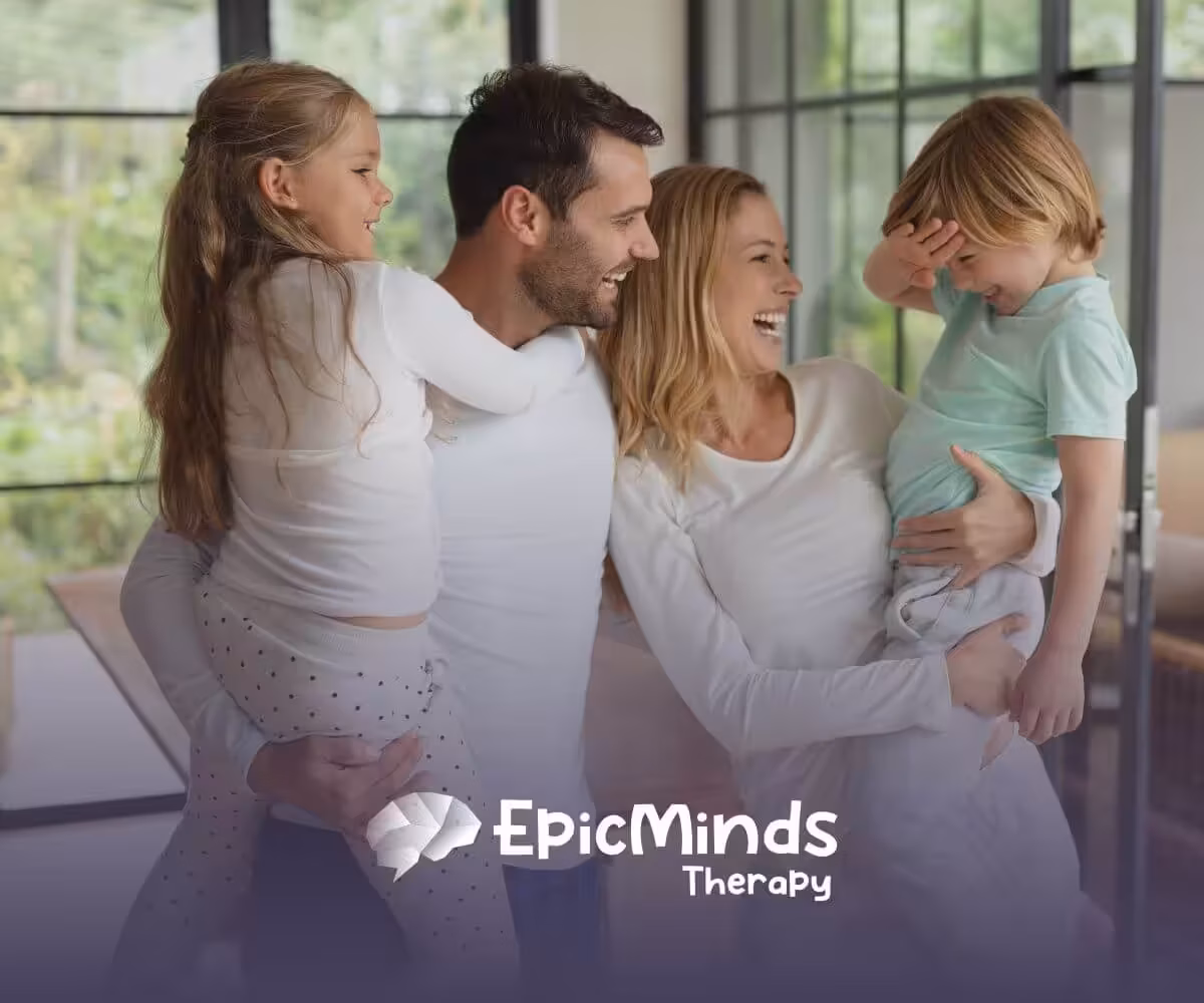 Family of four laughing and enjoying together before ABA therapy begins.