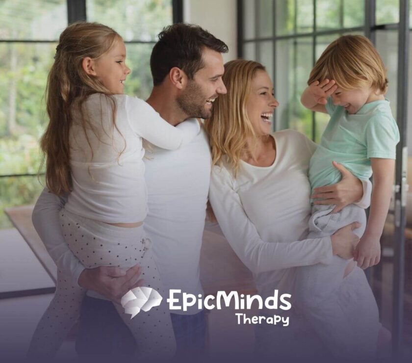 Family of four laughing and enjoying together before ABA therapy begins.