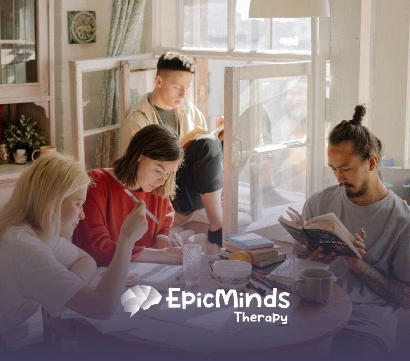BCBA student in library looking tired while studying, surrounded by open books and a lamp in MD.