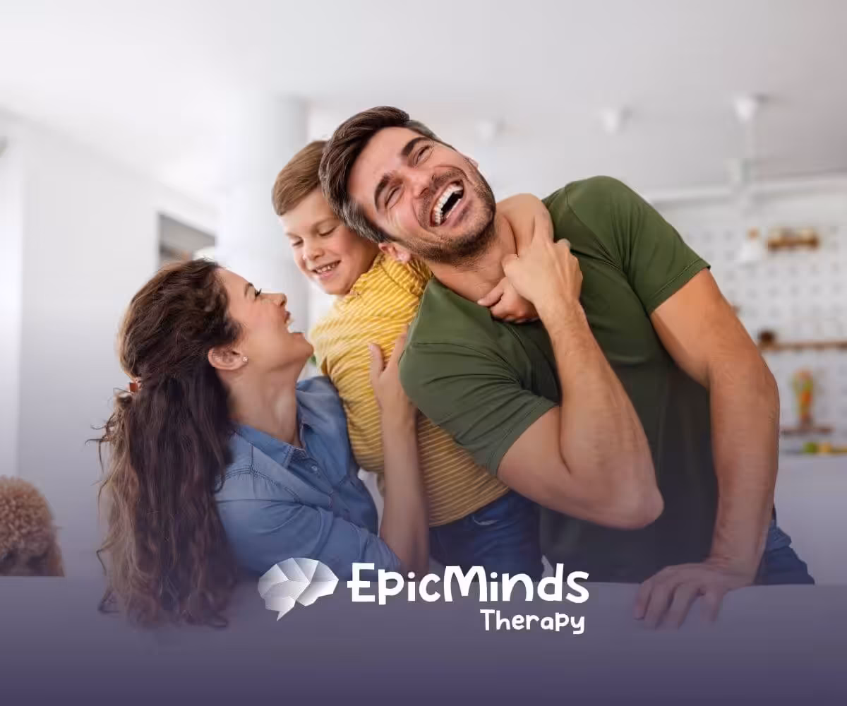 Happy family laughing together on a couch with their dog nearby.