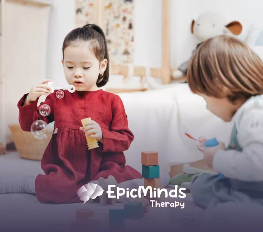 An autistic girl holding and inspecting a wooden toy helicopter at a table during ABA therapy in MD.
