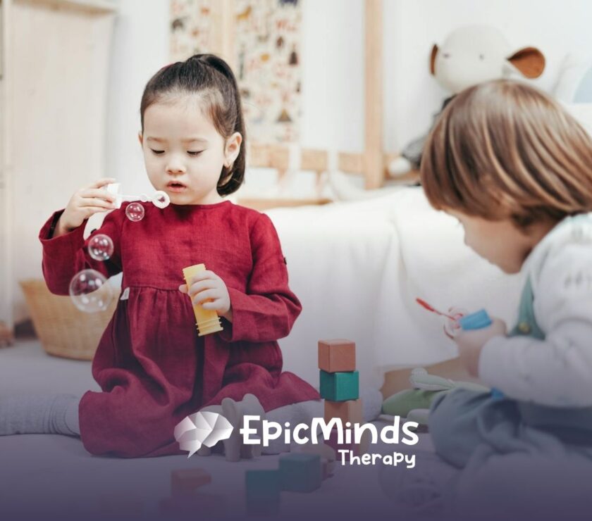 An autistic girl holding and inspecting a wooden toy helicopter at a table during ABA therapy in MD.