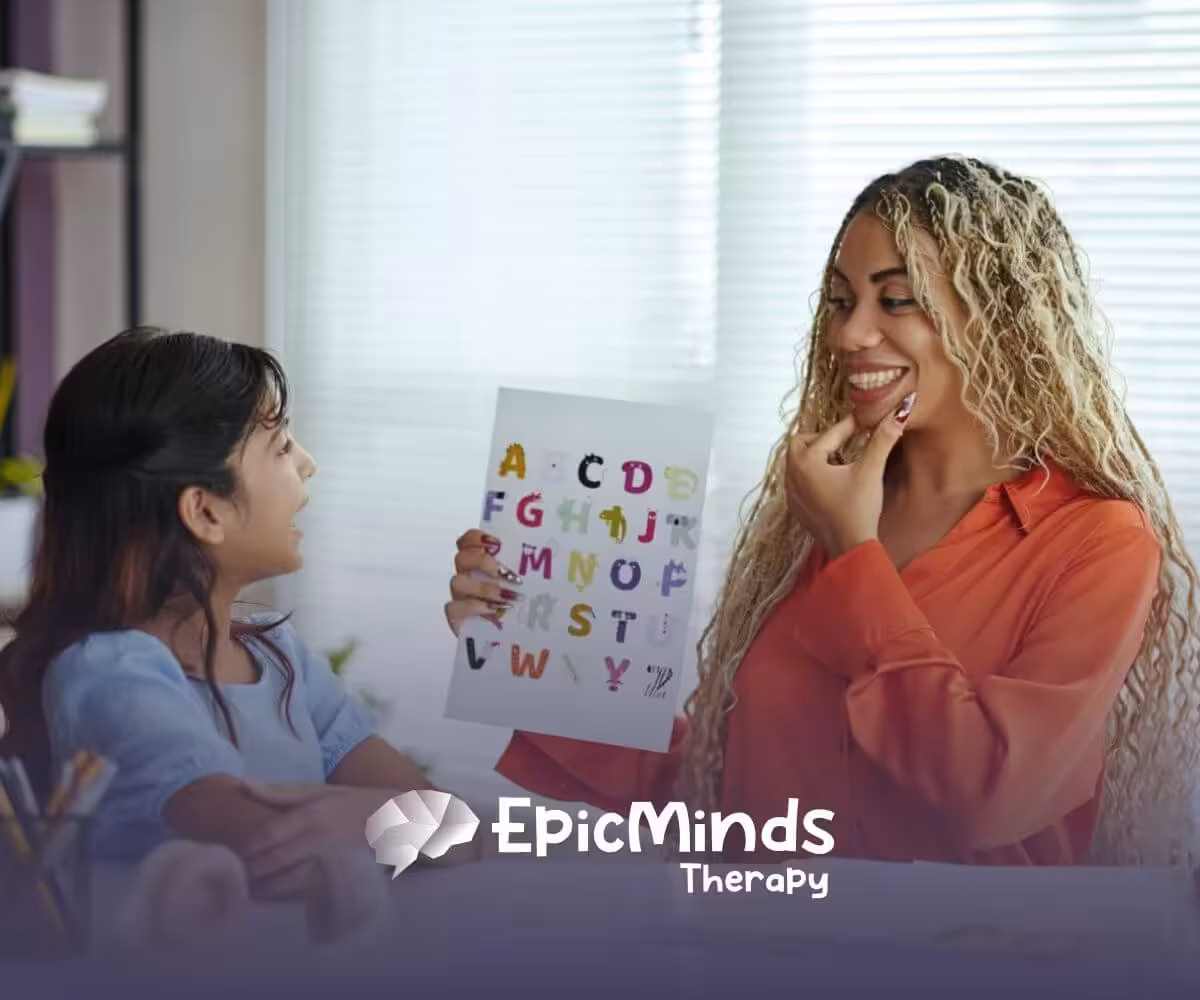 ABA therapist teaches a child the alphabet using colorful flashcards in a bright classroom in ABA therapy.
