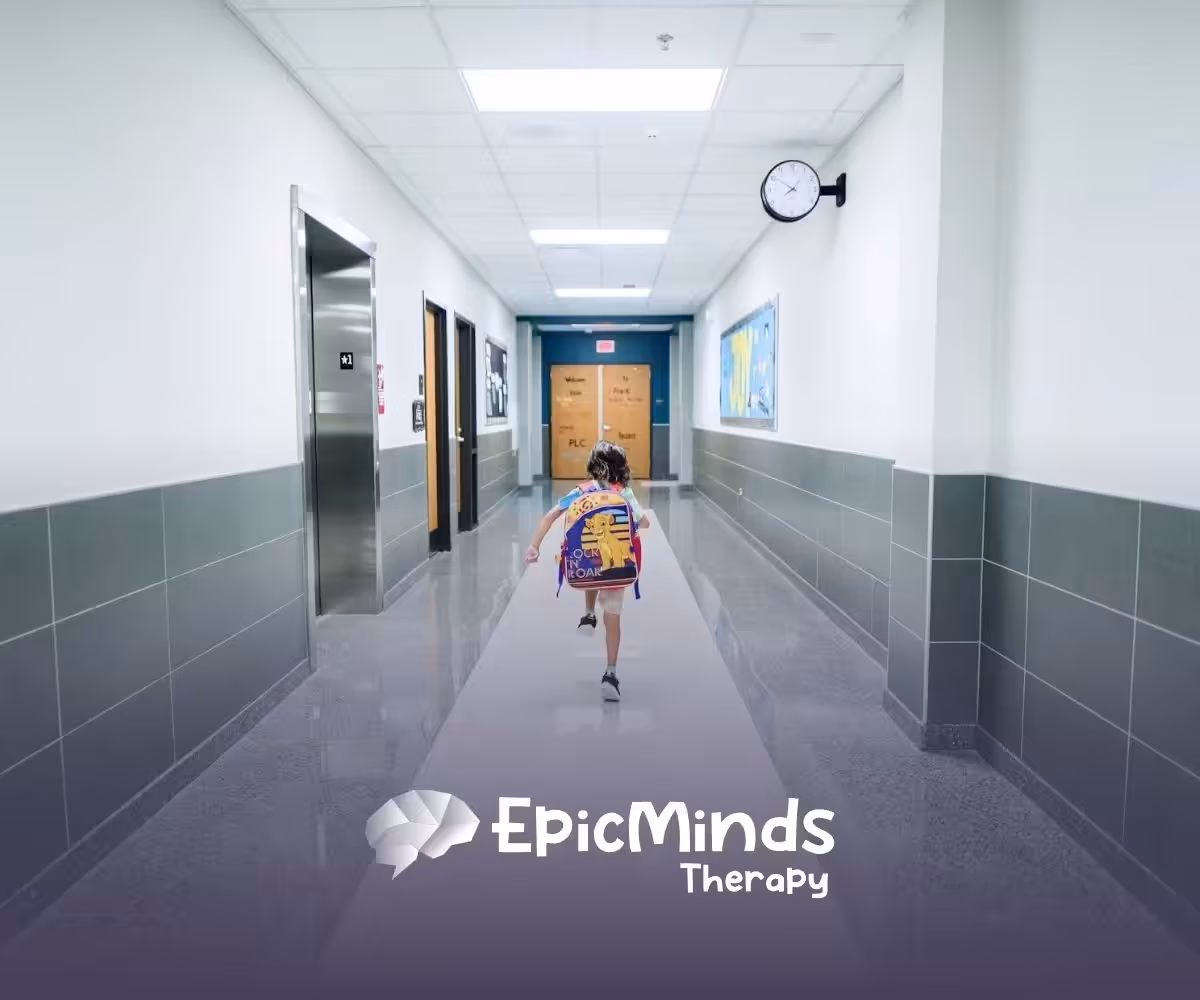 Autistic child walking down a school hallway with a backpack, heading to ca school-based ABA therapy in North Carolina.
