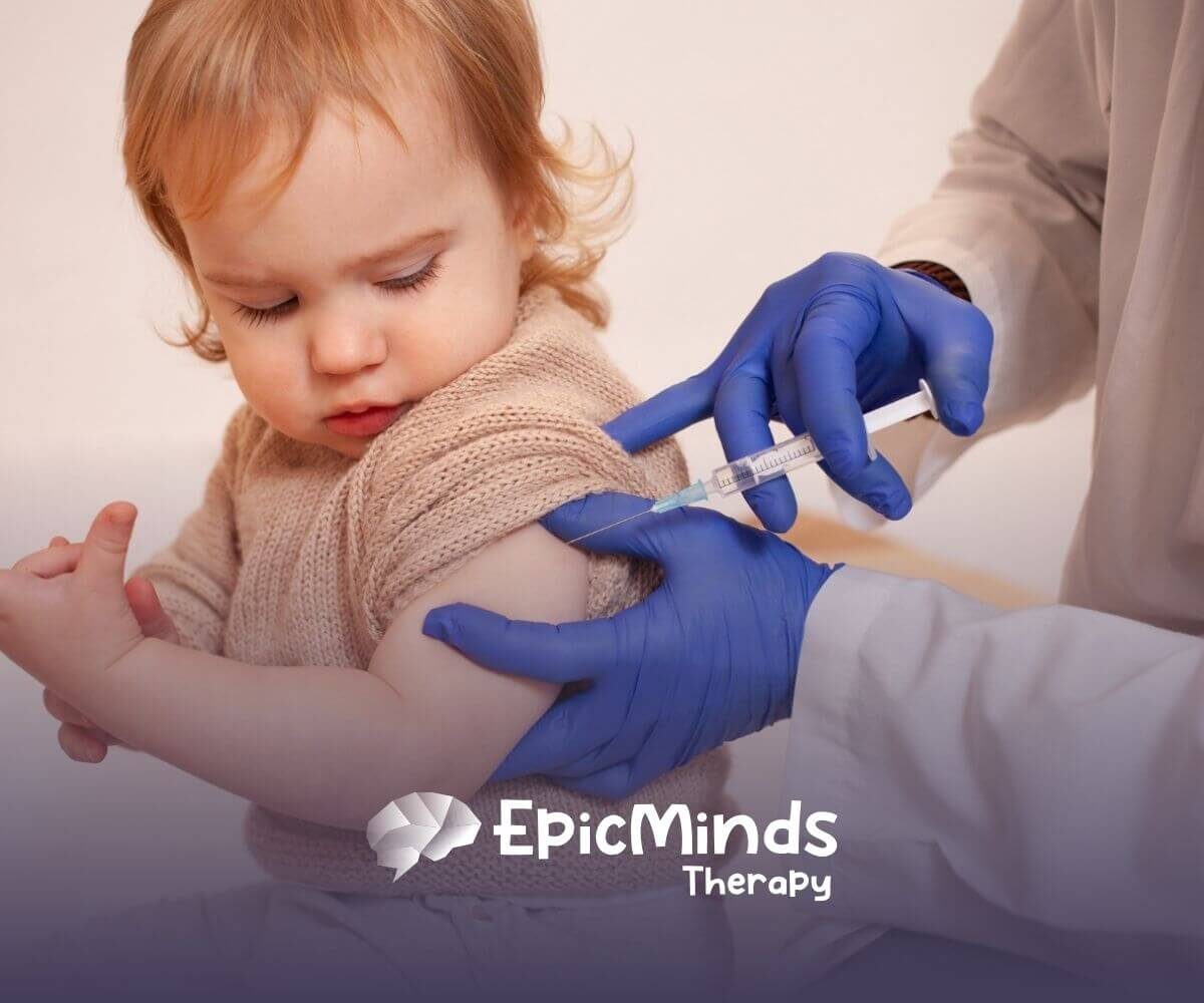 A toddler with autism receiving a vaccine shot in the upper arm.