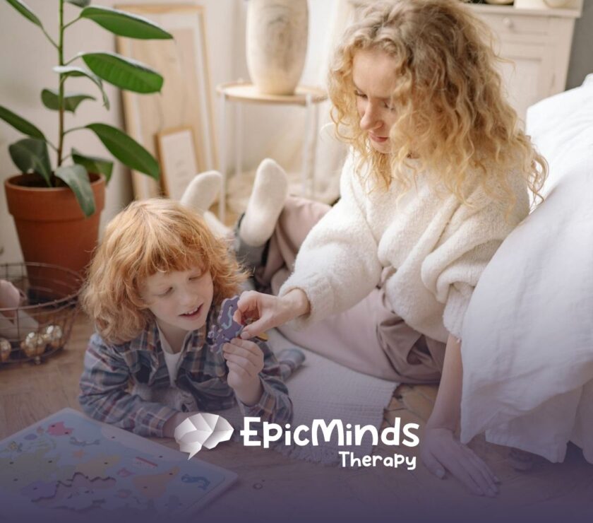 An ABA therapist and autistic child doing a world map puzzle on the floor together during in-home ABA therapy in NC.