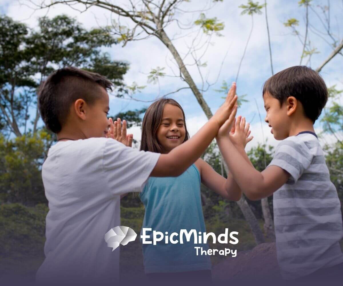 Three children in NC playing a hand-clapping game outdoors.