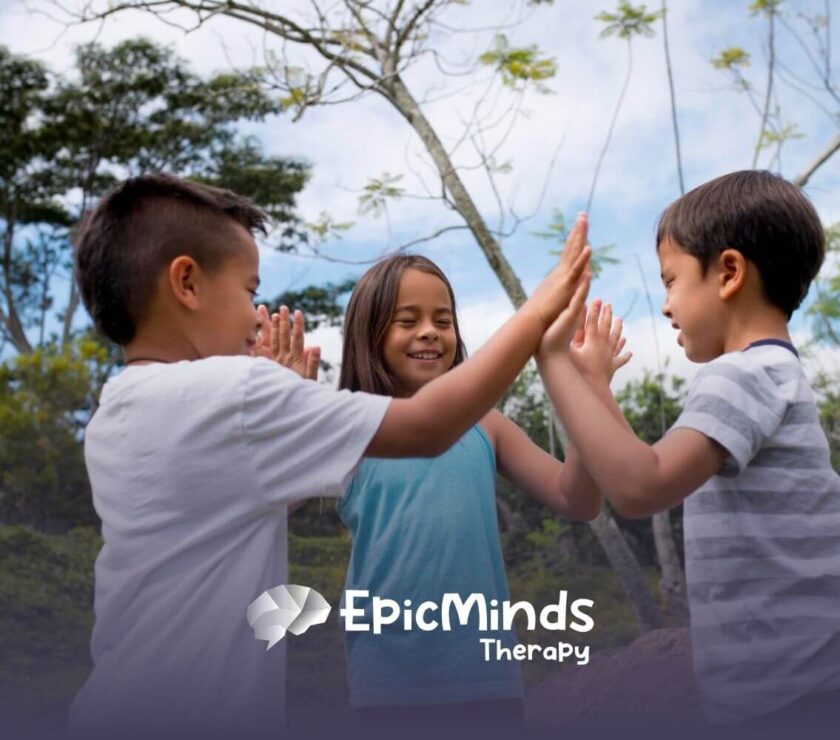 Three children in NC playing a hand-clapping game outdoors.