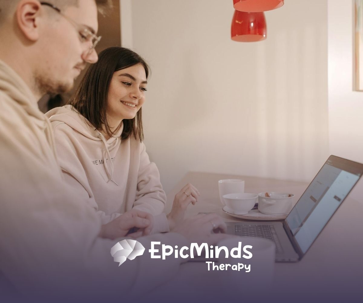 An RBT and RBT supervisor smiling while explaining the RBT supervision requirements at a laptop in North Carolina.