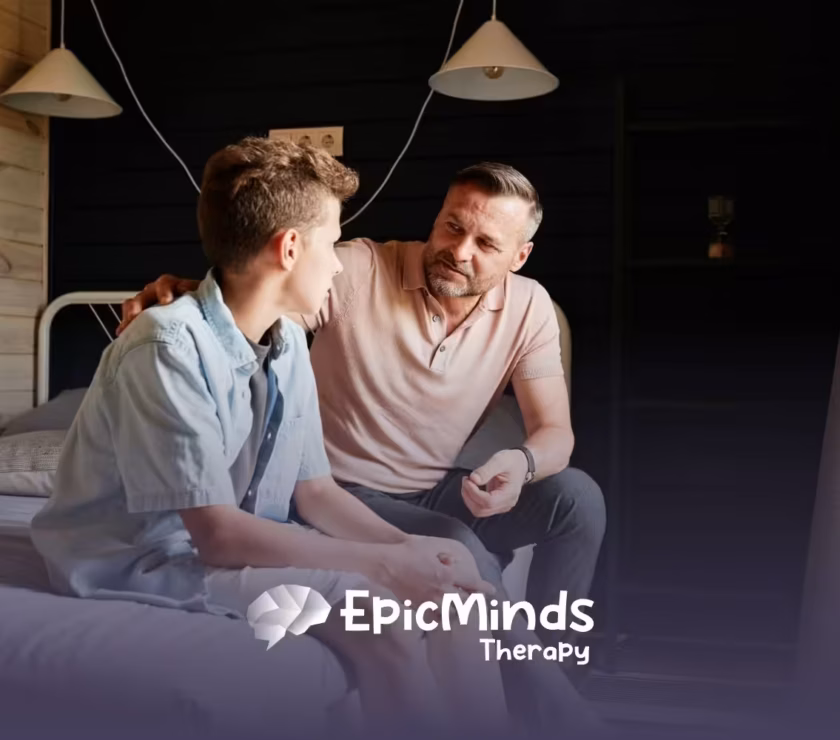 An ABA therapist and autistic child having a serious conversation while sitting on a bed in a cozy room in North Carolina.