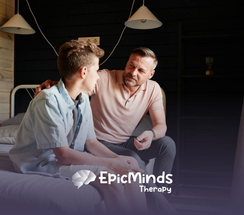 An ABA therapist and autistic child having a serious conversation while sitting on a bed in a cozy room in North Carolina.