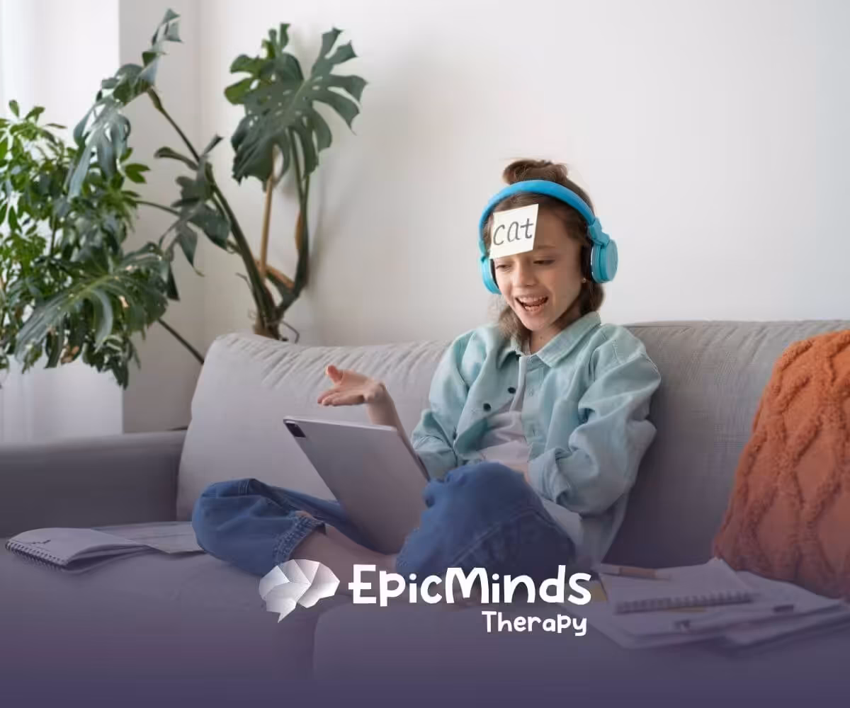 A girl with headphones and a "Cat" label on her forehead laughs while playing a guessing game on a tablet.