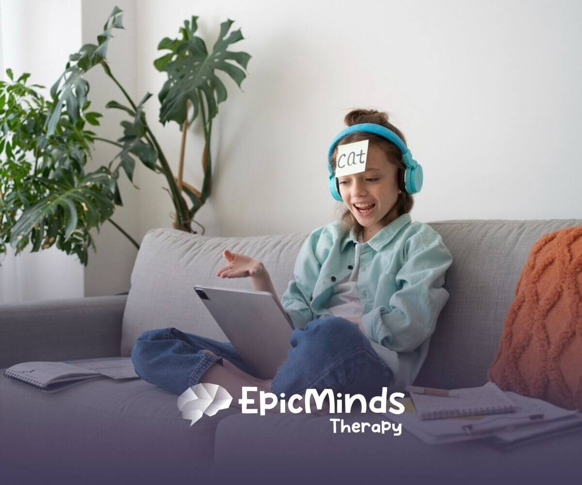 A girl with headphones and a "Cat" label on her forehead laughs while playing a guessing game on a tablet.