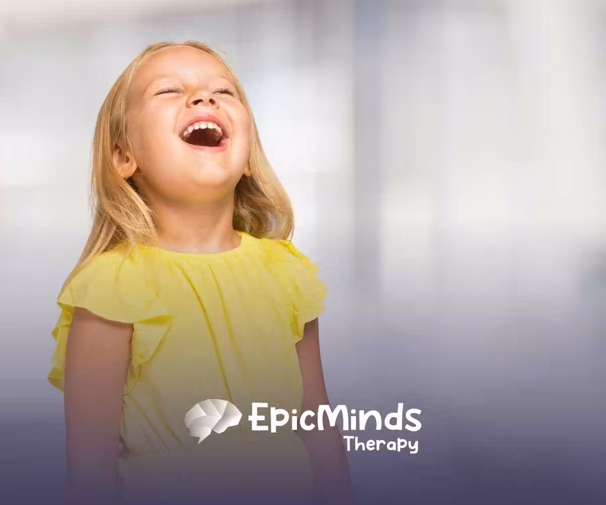 A joyful young girl in a bright yellow dress laughs with her head tilted back, set against a blurred, light background.