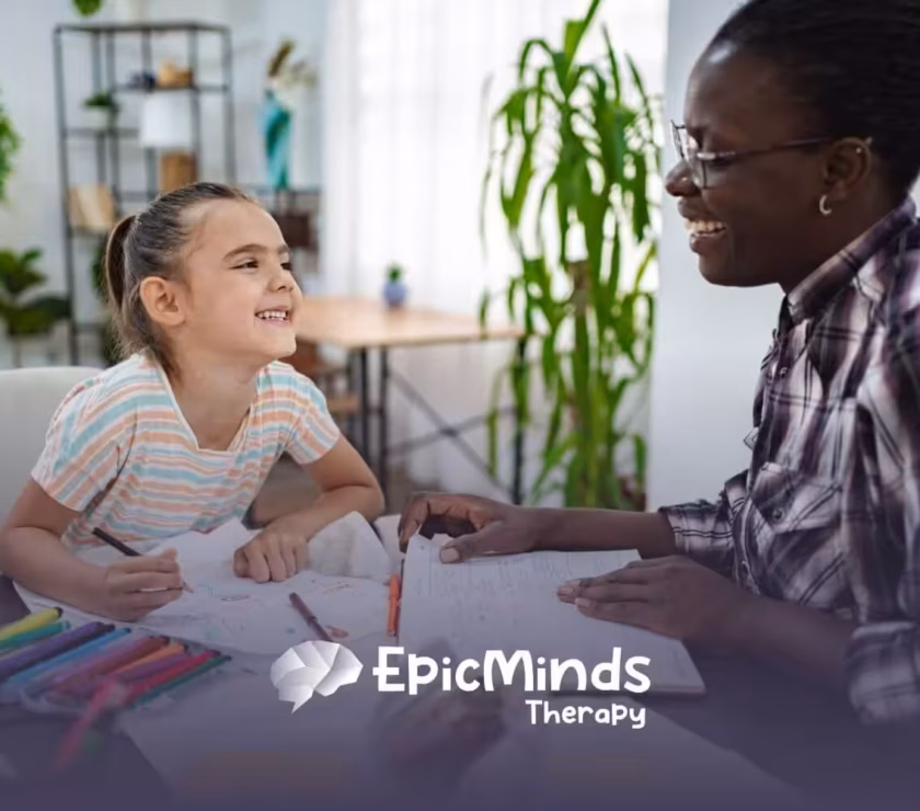 BCBA and autistic child laughing together during an activity in ABA therapy.