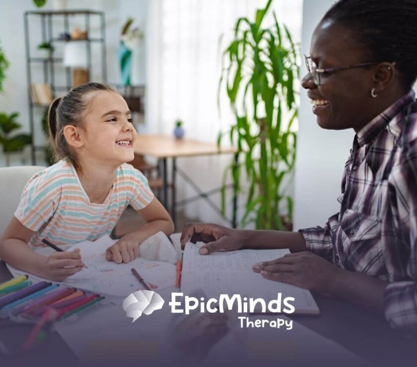 BCBA and autistic child laughing together during an activity in ABA therapy.
