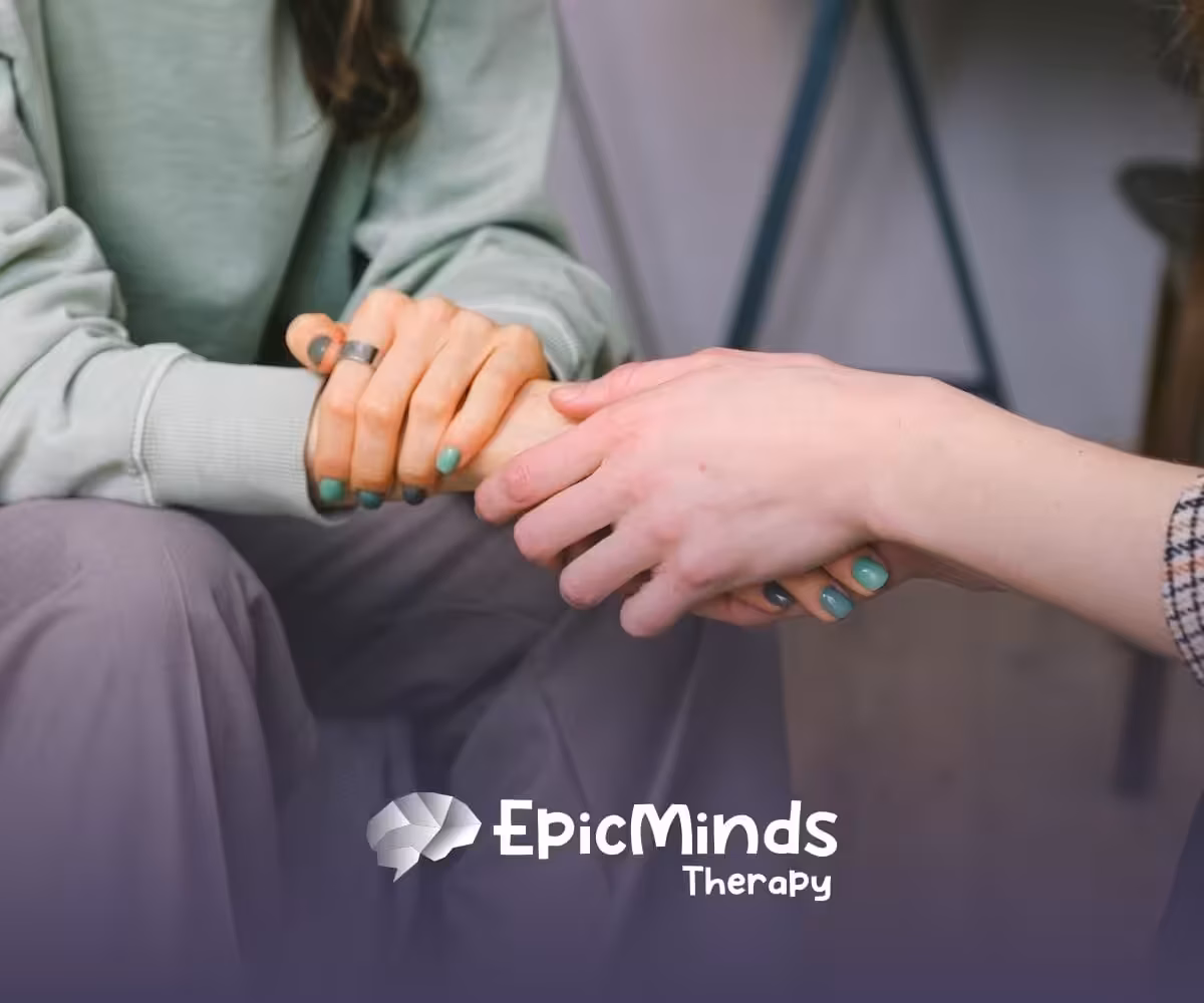 An ABA therapist held hands with the parent of an autistic child in a comforting gesture after autism diagnosis.