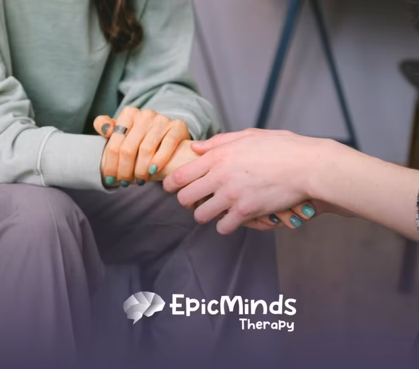 An ABA therapist held hands with the parent of an autistic child in a comforting gesture after autism diagnosis.