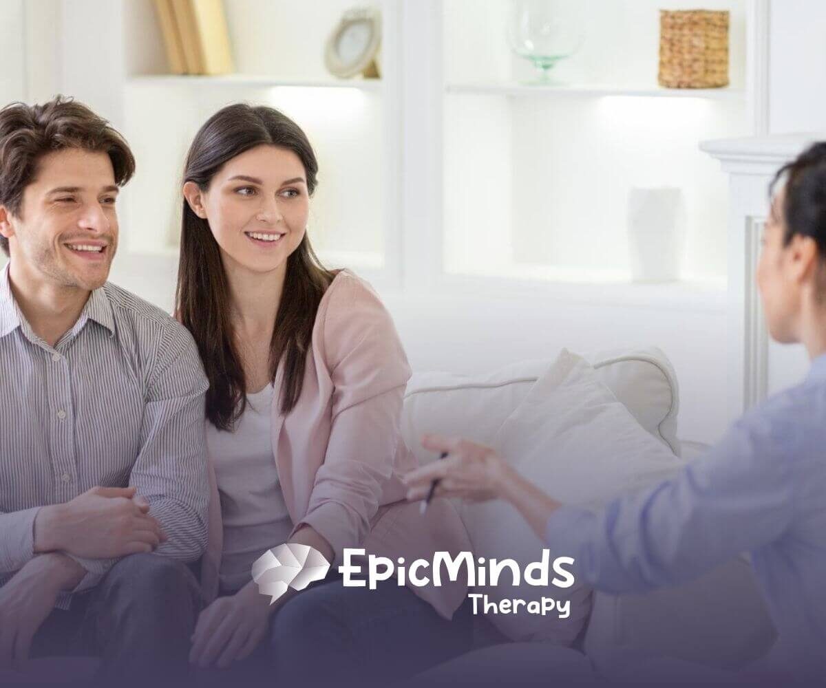 A couple talking with a BCBA during a parent training session.