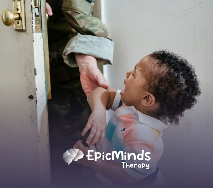 An autistic toddler crying while being held near a door by an ABA therapist in uniform during ABA therapy in NC.