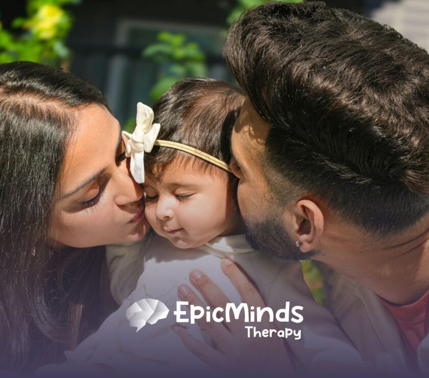 Mom and dad kiss their baby’s cheeks outside, sharing a sweet moment of love and connection in North Carolina.