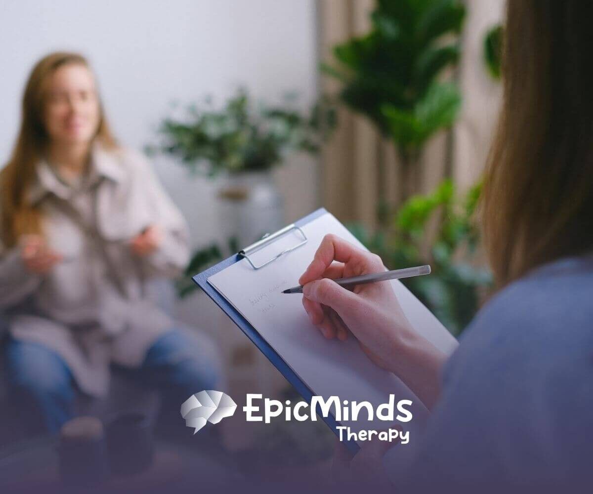 ABA Therapist writing notes during a counseling session with her applicant who is applying for the position for ABA Therapist