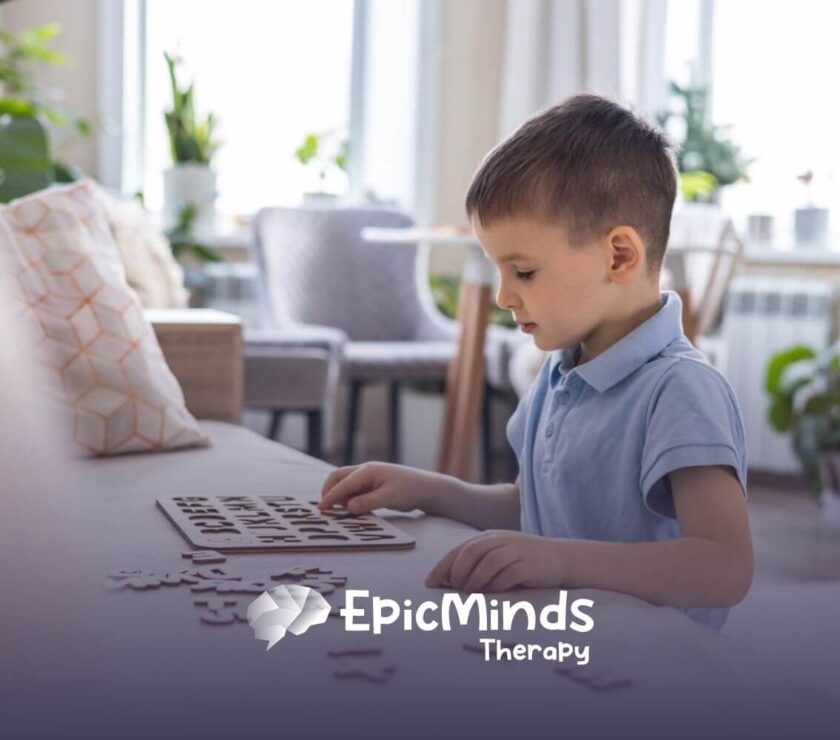 Child with autism focusing on colorful wooden shapes during ABA therapy.