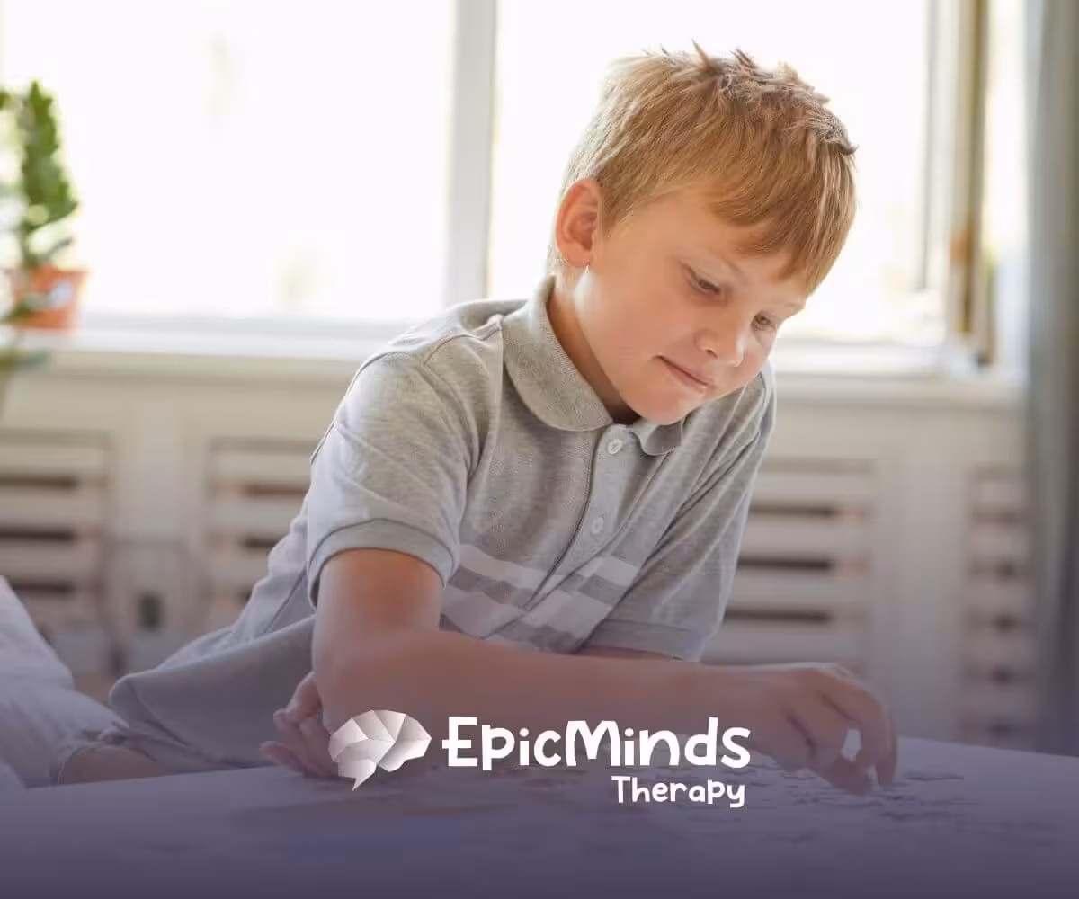 Boy with autism solving a puzzle at home during an educational activity.