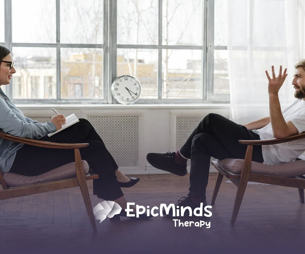 ABA Manager man speaks with a female therapist in a sunlit office during a counseling session in North Carolina.
