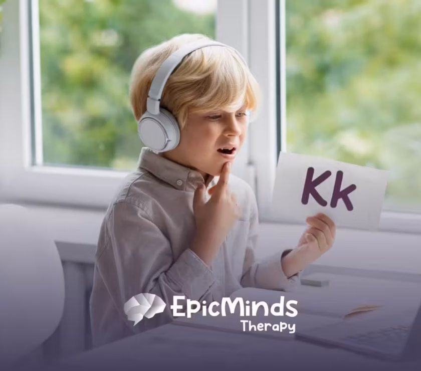 Boy with autism using flashcards and headphones while practicing speech online.