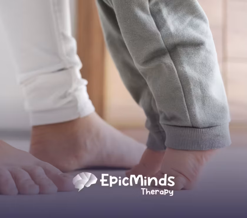 A mom assisting her child who is toe walking