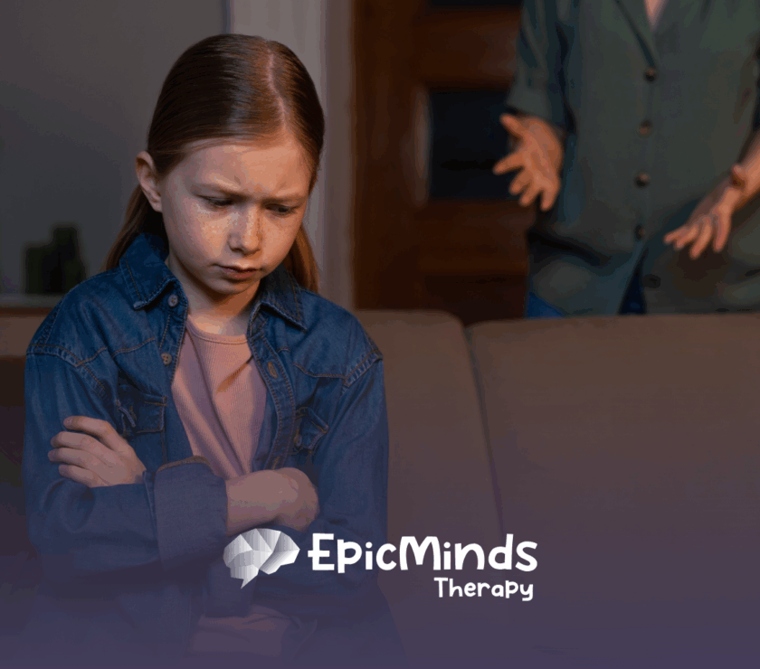 A kid with a frowning face sitting on a couch