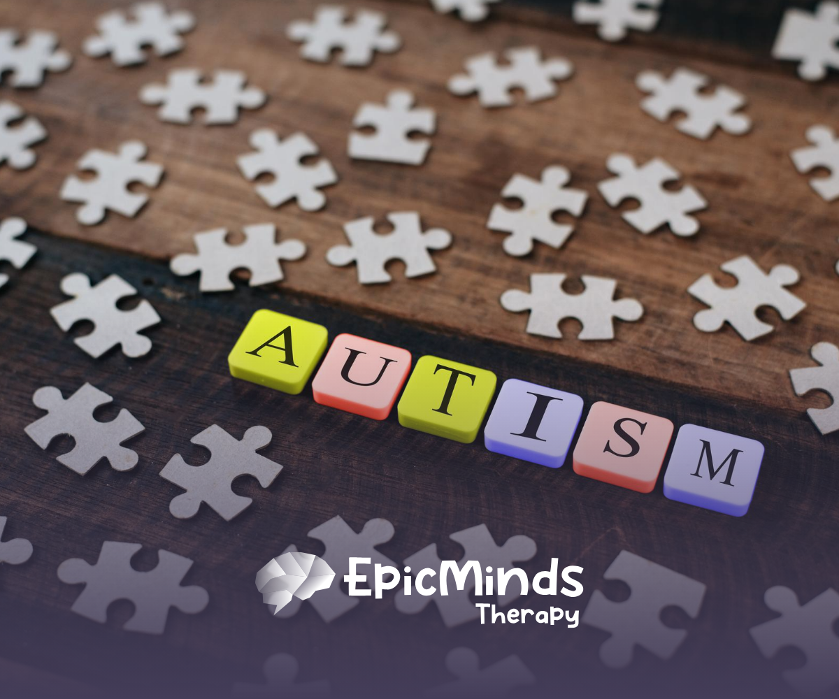 Colorful blocks spelling the word "autism" with puzzle peices around it