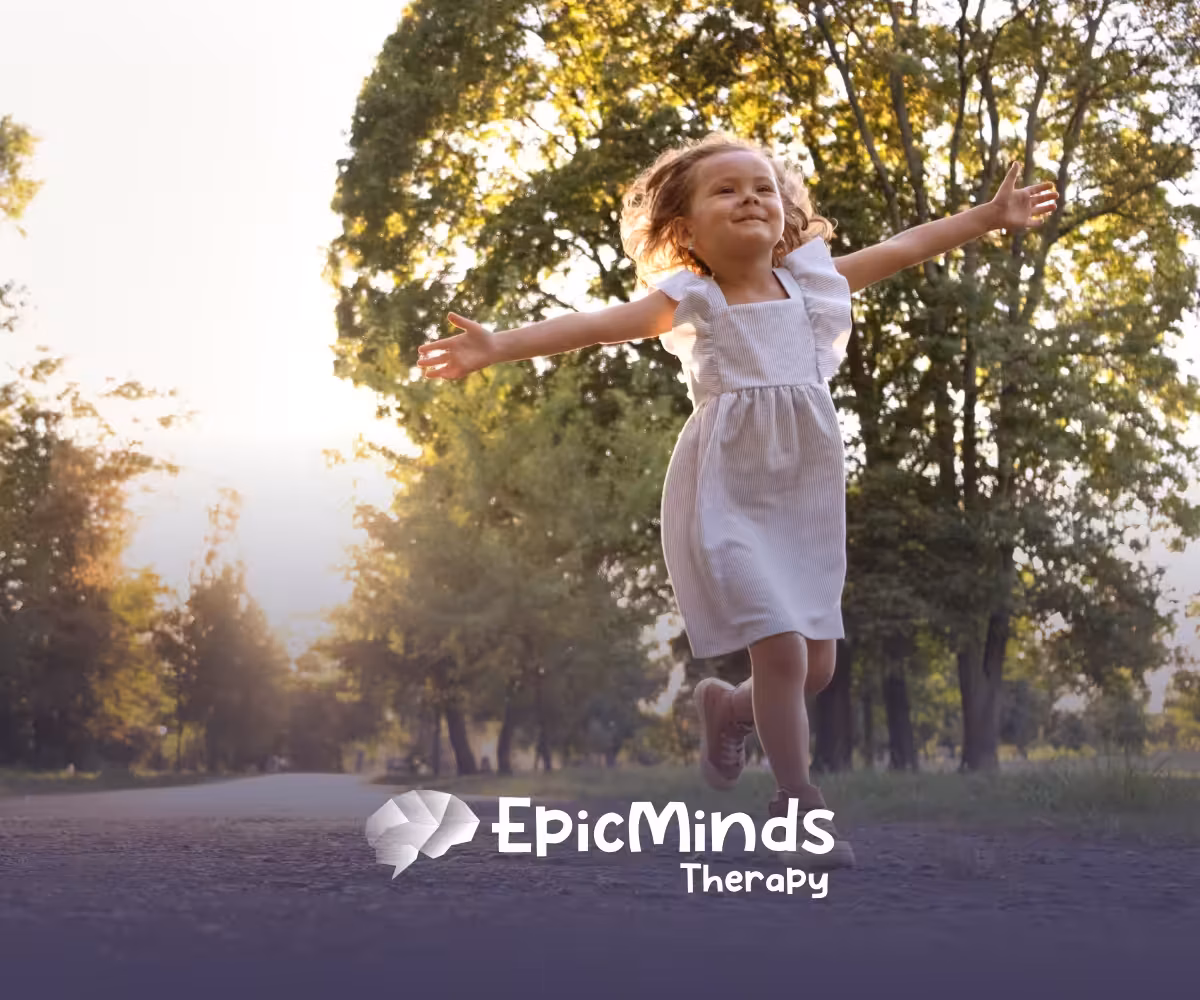 A girl happily running outdoors, arms open wide